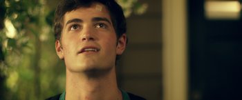 Movie still from “Max Steel” (2016), directed by Stewart Hendler – A man with a bandage on his face looking up; Close Up shot, Low angle