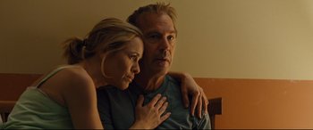 Movie still from “McFarland, USA” (2015), directed by Niki Caro – A man and a woman sitting next to each other; Close Up shot, Low angle