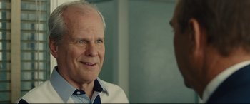 Movie still from “McFarland, USA” (2015), directed by Niki Caro – An older man wearing a white shirt is talking to someone; Close Up shot, Over the shoulder angle