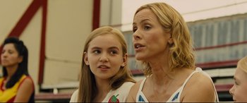 Movie still from “McFarland, USA” (2015), directed by Niki Caro – A woman standing next to a young girl in a room; Close Up shot, Over the shoulder angle