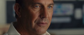 Movie still from “McFarland, USA” (2015), directed by Niki Caro – A man's face with blue eyes; Close Up shot, Over the shoulder angle