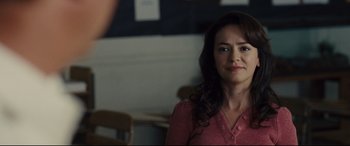 Movie still from “McFarland, USA” (2015), directed by Niki Caro – A woman in a pink shirt is standing in front of a mirror; Close Up shot, Over the shoulder angle