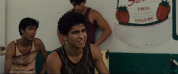 Movie still from “McFarland, USA” (2015), directed by Niki Caro – A young man smiling while standing next to another young man; Close Up shot, Over the shoulder angle