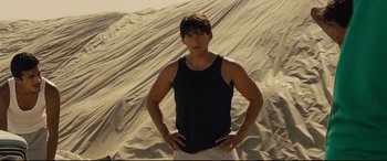 Movie still from “McFarland, USA” (2015), directed by Niki Caro – A man standing on top of a sand dune; Medium shot, Low angle