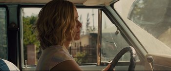 Movie still from “McFarland, USA” (2015), directed by Niki Caro – A woman sitting in the driver's seat of a car; Close Up shot, Over the shoulder angle