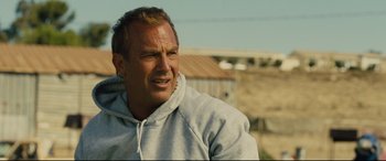 Movie still from “McFarland, USA” (2015), directed by Niki Caro – A person wearing a hooded sweatshirt; Close Up shot, Over the shoulder angle