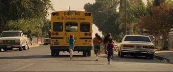 Movie still from “McFarland, USA” (2015), directed by Niki Caro – A group of children running to get on a school bus; Extreme Wide shot, High angle