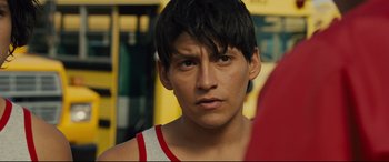 Movie still from “McFarland, USA” (2015), directed by Niki Caro – A person wearing a red and white shirt; Close Up shot, Over the shoulder angle