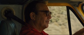 Movie still from “McFarland, USA” (2015), directed by Niki Caro – A person wearing glasses and a red shirt; Close Up shot, Over the shoulder angle