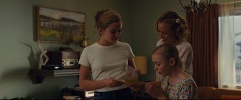Movie still from “McFarland, USA” (2015), directed by Niki Caro – A group of young people looking at a piece of paper; Medium shot, Over the shoulder angle