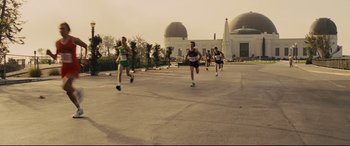 Movie still from “McFarland, USA” (2015), directed by Niki Caro – A group of people running on a road; Wide shot, High angle