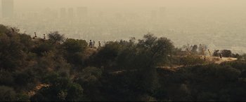 Movie still from “McFarland, USA” (2015), directed by Niki Caro – A view of a city from a hill with trees in the foreground; Extreme Wide shot, High angle