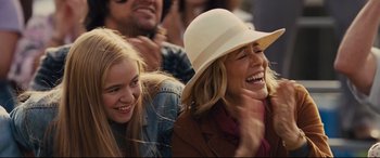Movie still from “McFarland, USA” (2015), directed by Niki Caro – Two women and a man are laughing together; Close Up shot, Over the shoulder angle