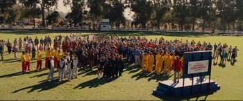 Movie still from “McFarland, USA” (2015), directed by Niki Caro – A large group of people standing on a field; Extreme Wide shot, High angle