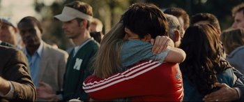 Movie still from “McFarland, USA” (2015), directed by Niki Caro – Two people hugging each other in a crowd of onlookers; Close Up shot, Over the shoulder angle