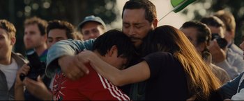 Movie still from “McFarland, USA” (2015), directed by Niki Caro – A group of people hugging each other in a crowd; Close Up shot, Low angle