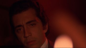 Movie still from “Mean Streets” (1973), directed by Martin Scorsese – A person wearing a suit and tie; Close Up shot, Low angle