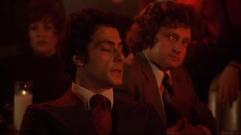 Movie still from “Mean Streets” (1973), directed by Martin Scorsese – A man in a suit and tie next to another man in a suit and tie; Close Up shot, Low angle