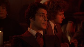 Movie still from “Mean Streets” (1973), directed by Martin Scorsese – A man in a suit and tie looking up; Close Up shot, Low angle