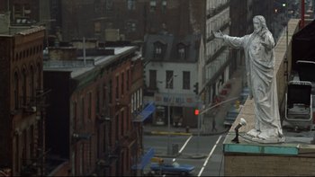 Movie still from “Mean Streets” (1973), directed by Martin Scorsese – An aerial view of a city street and buildings; Wide shot, Low angle