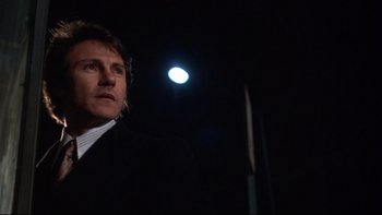 Movie still from “Mean Streets” (1973), directed by Martin Scorsese – A man standing in the dark under a street light; Close Up shot, Low angle