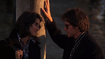 Movie still from “Mean Streets” (1973), directed by Martin Scorsese – A man and a woman high fiving near a tree; Close Up shot, Over the shoulder angle
