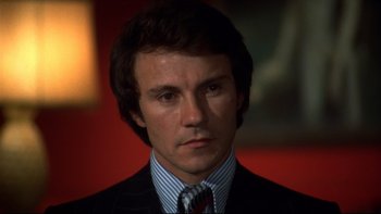 Movie still from “Mean Streets” (1973), directed by Martin Scorsese – A person wearing a suit and tie; Close Up shot, Low angle