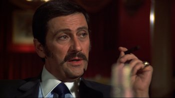 Movie still from “Mean Streets” (1973), directed by Martin Scorsese – A person talking on a cell phone; Close Up shot, Low angle