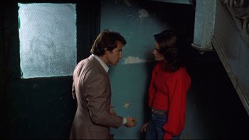 Movie still from “Mean Streets” (1973), directed by Martin Scorsese – A man and a woman standing next to each other in a room; Medium shot, Over the shoulder angle
