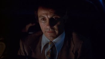 Movie still from “Mean Streets” (1973), directed by Martin Scorsese – A person wearing a suit and tie; Close Up shot, Low angle