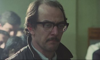 Movie still from “Meantime” (1983), directed by Mike Leigh – A person wearing glasses; Close Up shot, Low angle