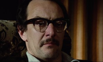 Movie still from “Meantime” (1983), directed by Mike Leigh – A person wearing glasses; Close Up shot, Low angle