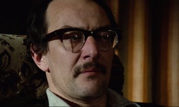 Movie still from “Meantime” (1983), directed by Mike Leigh – A person wearing glasses; Close Up shot, Low angle