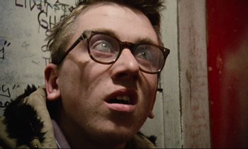 Movie still from “Meantime” (1983), directed by Mike Leigh – A person wearing glasses; Close Up shot, Low angle