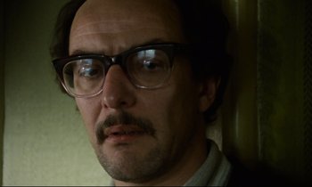 Movie still from “Meantime” (1983), directed by Mike Leigh – A person wearing glasses; Close Up shot, Low angle