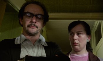 Movie still from “Meantime” (1983), directed by Mike Leigh – A man and a woman standing next to each other; Close Up shot, Low angle