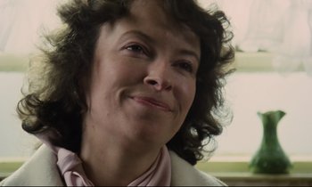 Movie still from “Meantime” (1983), directed by Mike Leigh – A person with curly brown hair; Close Up shot, Low angle