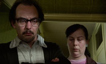 Movie still from “Meantime” (1983), directed by Mike Leigh – A man and a woman are standing next to each other; Close Up shot, Low angle