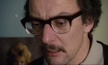 Movie still from “Meantime” (1983), directed by Mike Leigh – A person wearing glasses; Close Up shot, Low angle