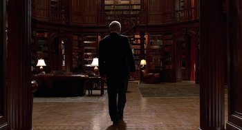 Movie still from “Meet Joe Black” (1998), directed by Martin Brest – A man in a suit walks through a library; Wide shot, Low angle