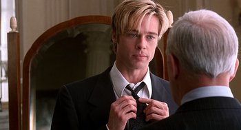 Movie still from “Meet Joe Black” (1998), directed by Martin Brest – A man in a suit is tying his tie; Close Up shot, Over the shoulder angle