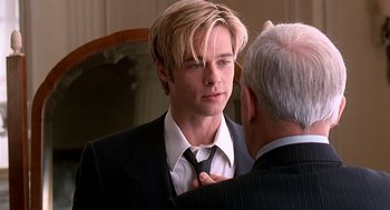 Movie still from “Meet Joe Black” (1998), directed by Martin Brest – A man in a suit and tie adjusting another man's neck tie; Close Up shot, Over the shoulder angle