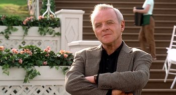 Movie still from “Meet Joe Black” (1998), directed by Martin Brest – An older man in a suit and tie; Medium shot, Low angle