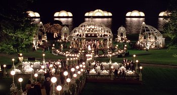 Movie still from “Meet Joe Black” (1998), directed by Martin Brest – A group of people standing around a gazebo at night; Extreme Wide shot, High angle