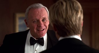 Movie still from “Meet Joe Black” (1998), directed by Martin Brest – A man in a tuxedo talking to another man in a suit; Close Up shot, Over the shoulder angle