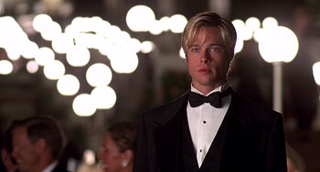 Movie still from “Meet Joe Black” (1998), directed by Martin Brest – A man in a tuxedo standing in front of lights; Close Up shot, Low angle