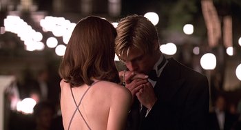 Movie still from “Meet Joe Black” (1998), directed by Martin Brest – A man and a woman in formal wear kissing; Close Up shot, Over the shoulder angle