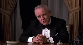Movie still from “Meet Joe Black” (1998), directed by Martin Brest – A person sitting at a table wearing a tuxedo; Close Up shot, Low angle