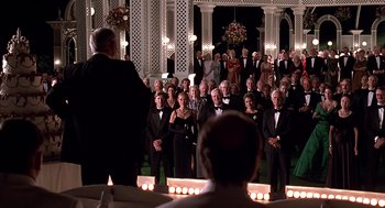 Movie still from “Meet Joe Black” (1998), directed by Martin Brest – A group of people in formal wear standing in front of a crowd; Wide shot, Low angle