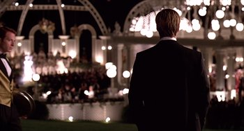 Movie still from “Meet Joe Black” (1998), directed by Martin Brest – A man standing in front of an audience at night; Medium shot, Over the shoulder angle
